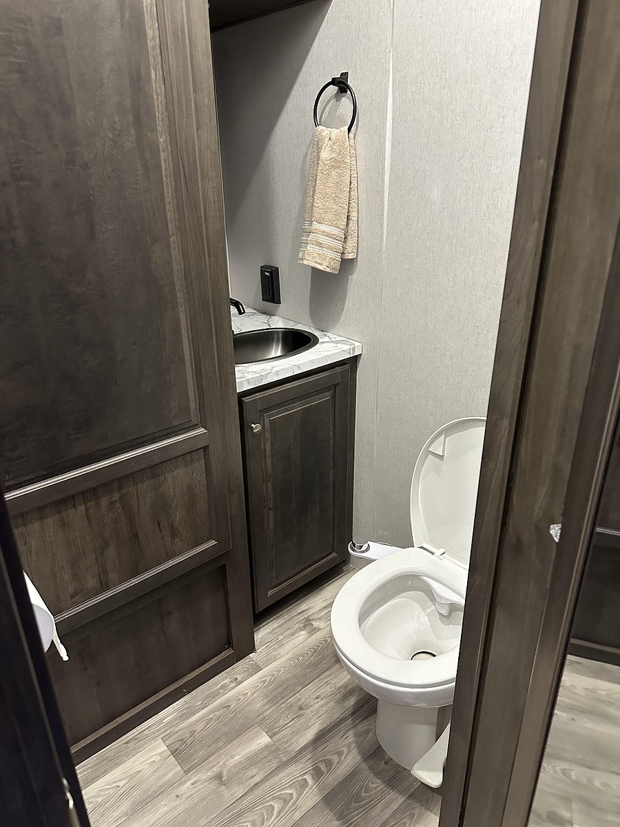Half bath right inside entry door so access not needed to bedroom.  Includes large storage area.