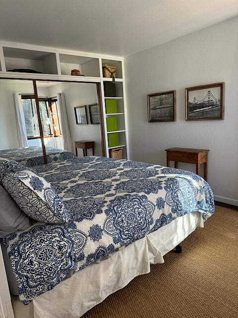 Second bed with tasteful art and a TV in the closet. 