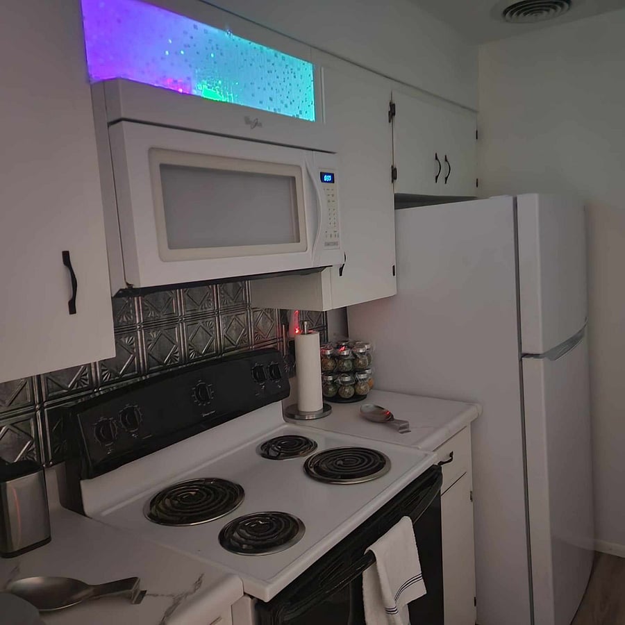 Full size range, farm sink, and refrigerator with ice maker.