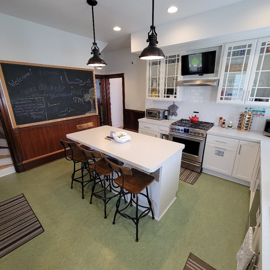 Kitchen has lots of pots, pans and more for use. The island seats 4 people.