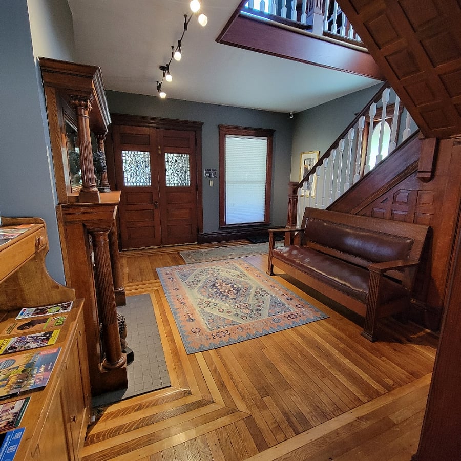 The main entrance has a wide staircase and beautiful leaded-glass windows in the interior entry doors.