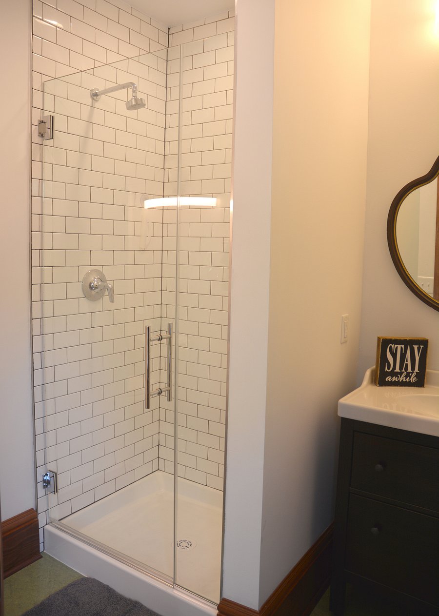 The en-suite bathroom for the blue room has a stand-up shower with subway tile.