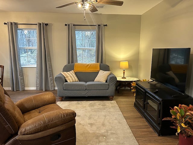 Comfortable living room with a new recliner and small sofa.