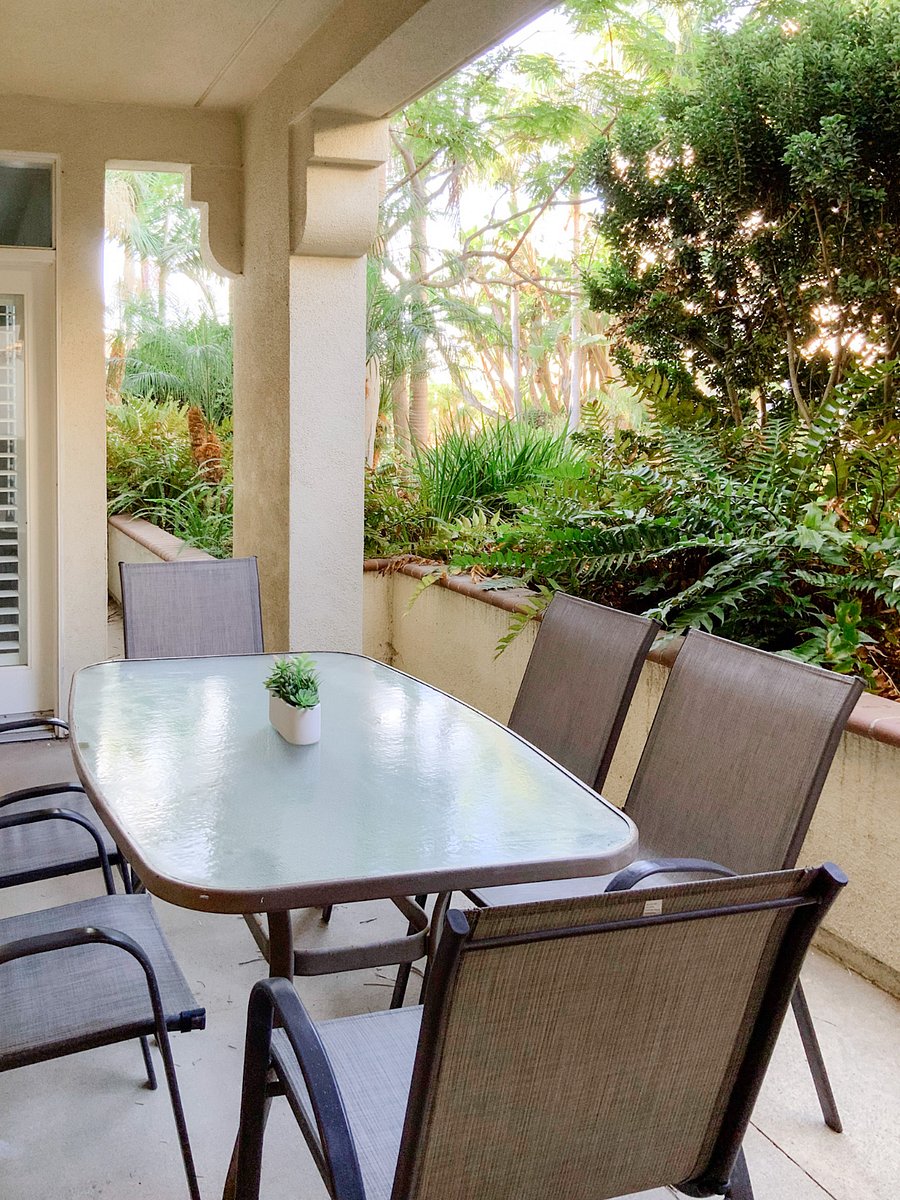 Private Patio: Dine and Unwind Outdoors at a Table for Six, Enclosed by Large Plants for Privacy, All Bathed in the Perfect Amount of Sunlight.