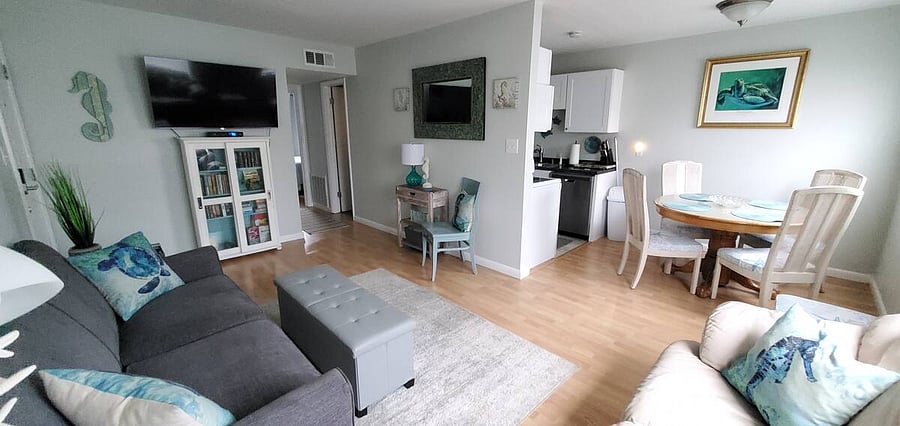 View of livingroom, leading to tow bedroom and a bathroom to the left, and the dining area to the right and full kitchen behind the wall!