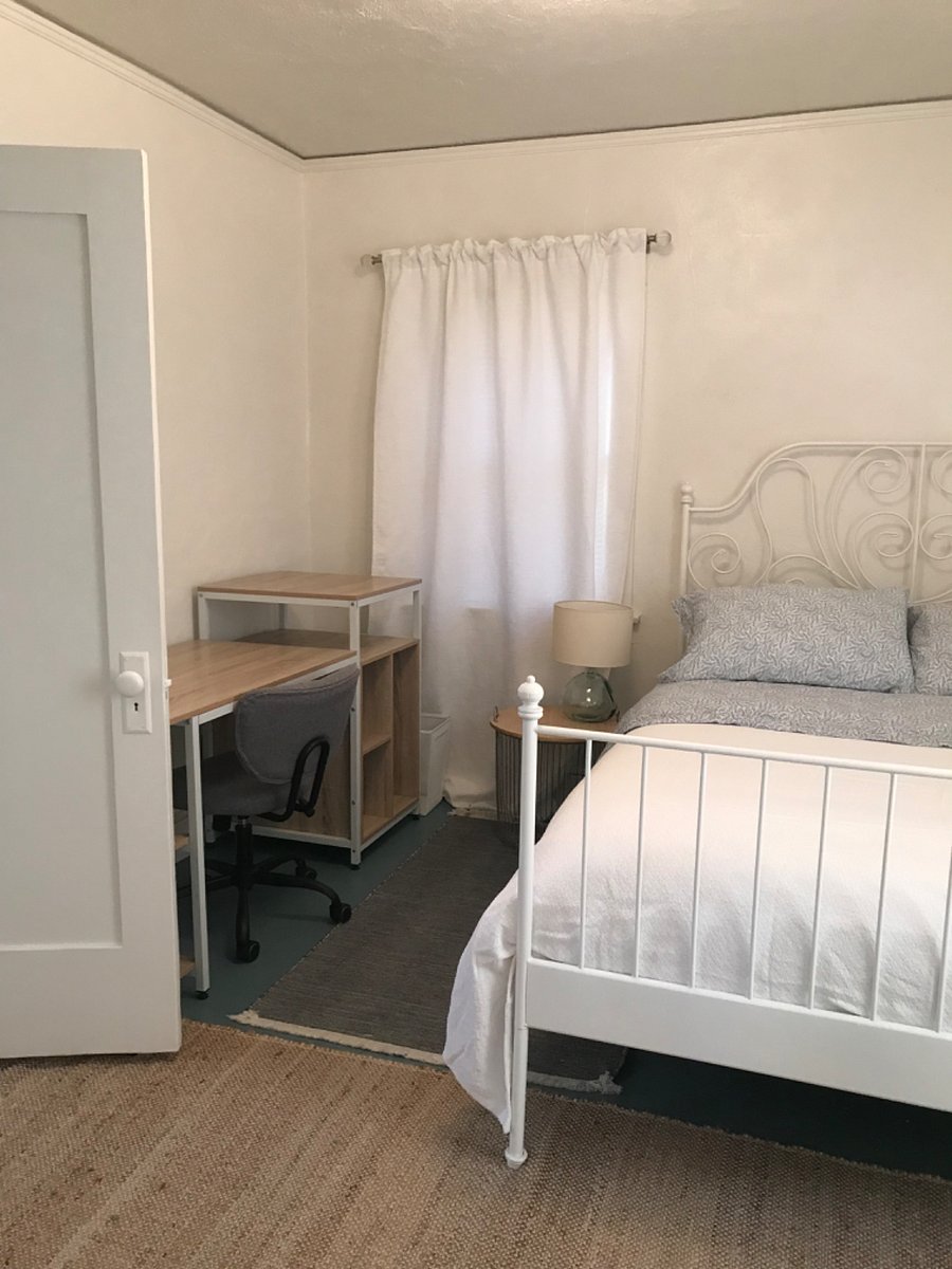 Second bedroom with a queen bed and desk.