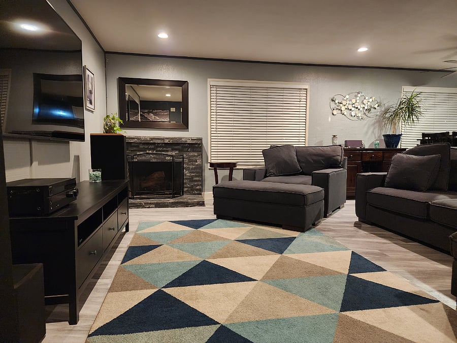 Living room with Smart TV, fireplace, extra-large comfortable couch.