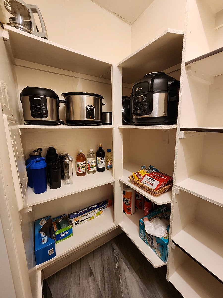 Kitchen pantry - Air fryer, crock pot, and rice pot. Starter foil, plastic bags, plastic wrap, and oils/vinegar.