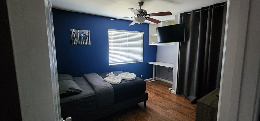 Bedroom #2 - Double size bed, ceiling fan, smart TV, desk, closet, and dresser.
