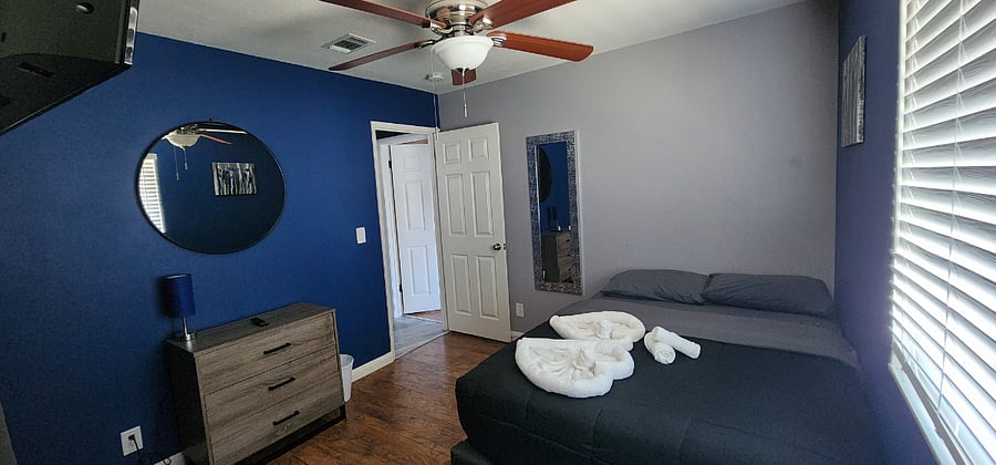 Bedroom #2 - Double size bed, ceiling fan, smart TV, desk, closet, and dresser.