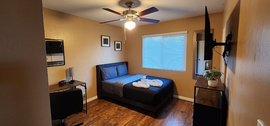 Bedroom #3 - Double size bed, ceiling fan, smart TV, desk, closet, and dresser.