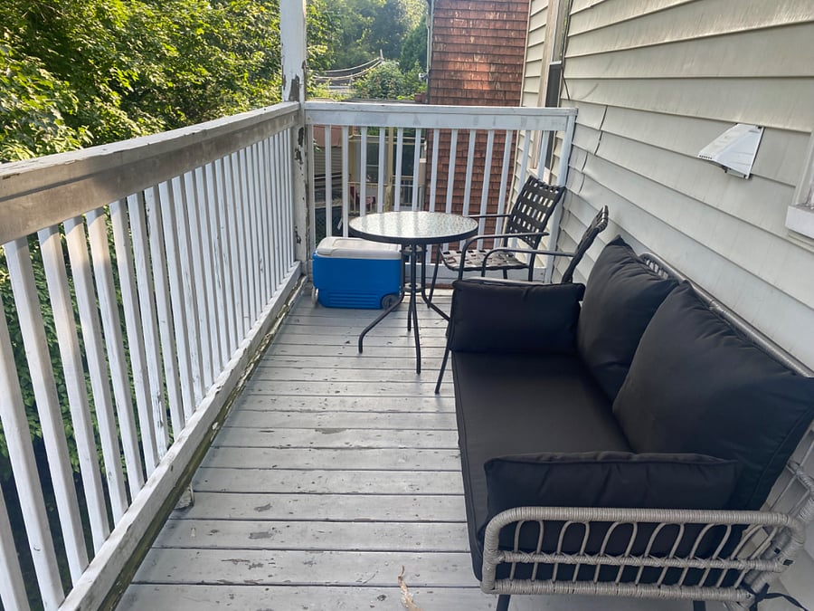 back deck features dining area, loveseat, and a stove