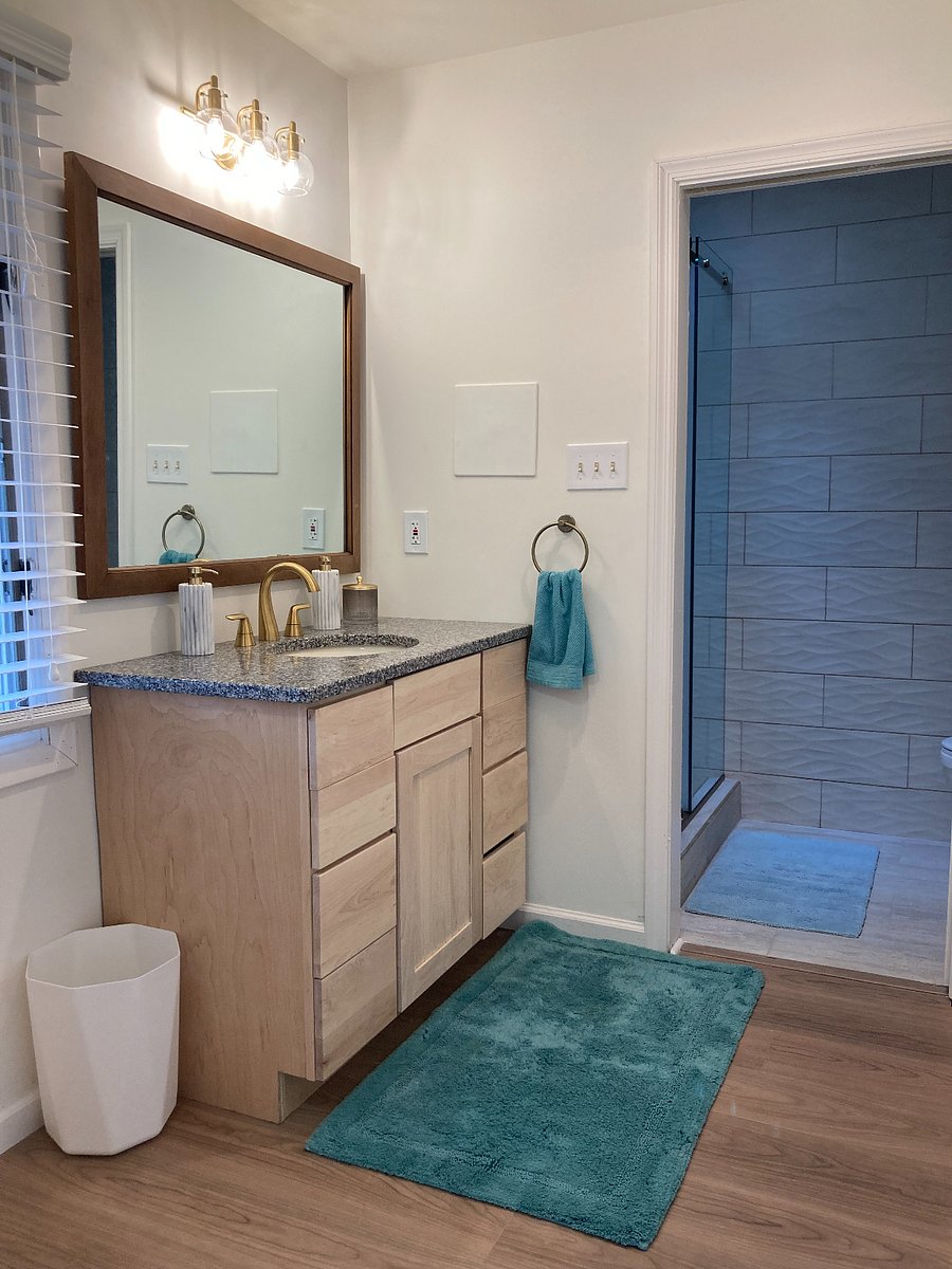 Bathroom with pocket door separating shower and toilet from vanity and laundry room