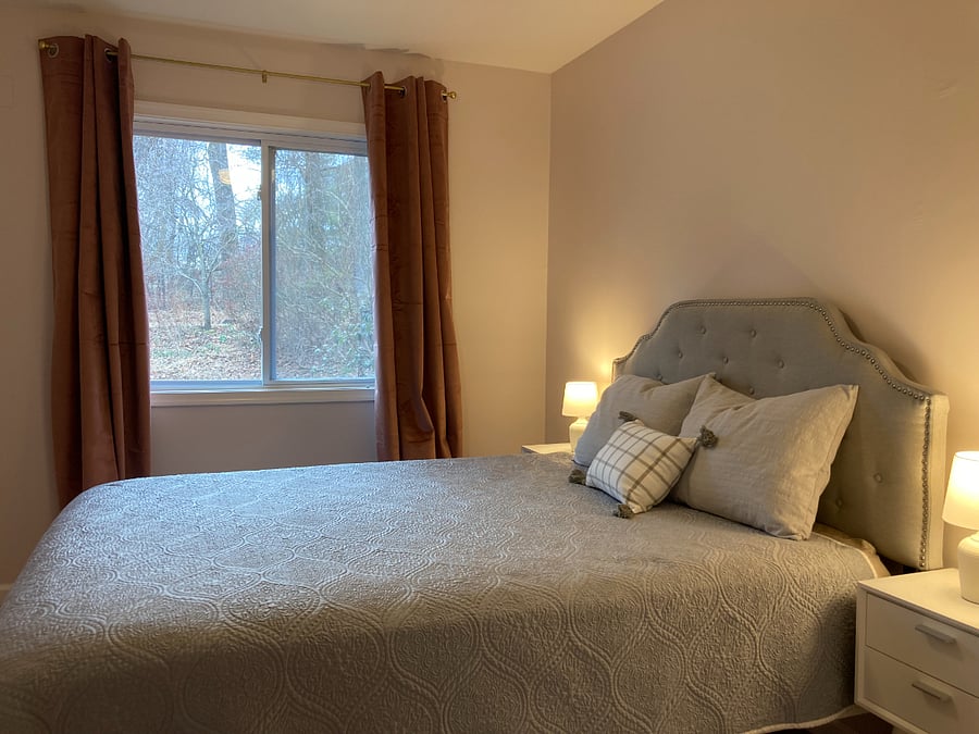 Second bedroom with large window and queen size bed