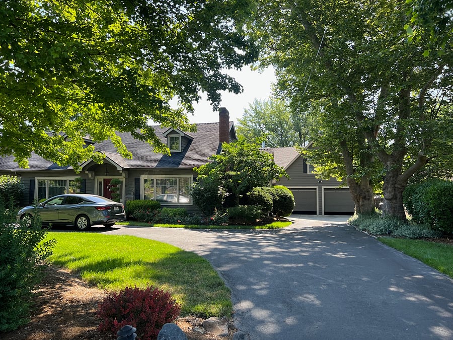 Street view-- apartment is located above the garage on the right.