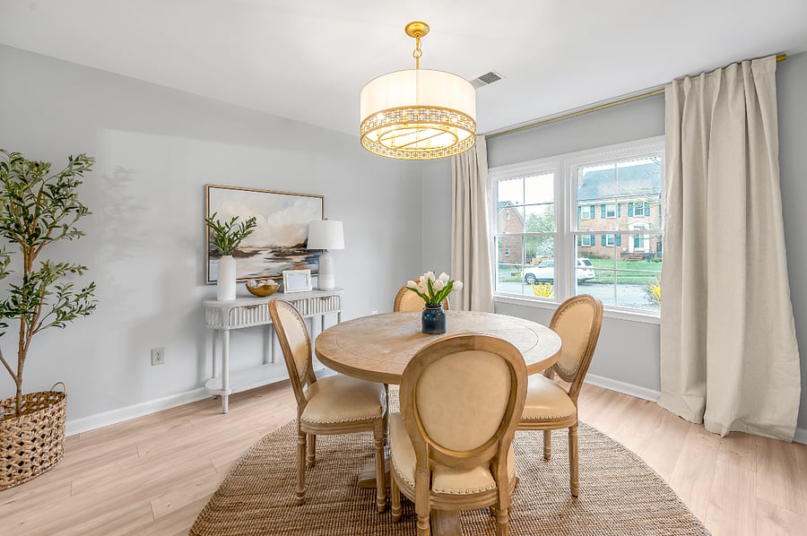 Dining room with table that can seat up to six with front window view