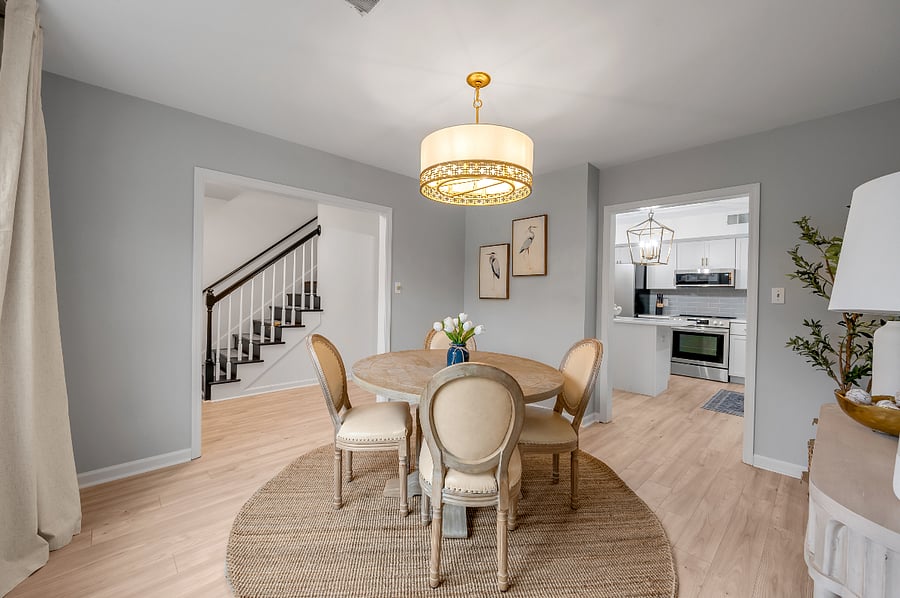 Dining room with kitchen and staircase view
