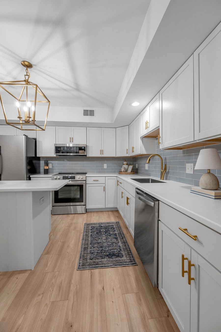 Completely renovated kitchen with brand new cabinets, tile, fixtures, countertops, lighting and appliances