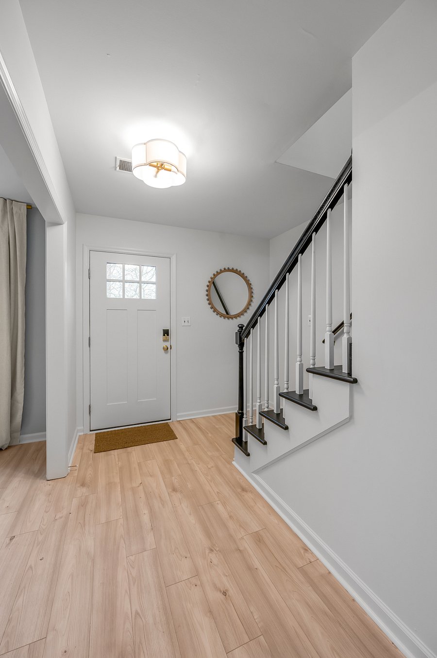 Front entryway, dining room to the left and staircase to 2nd level to the right
