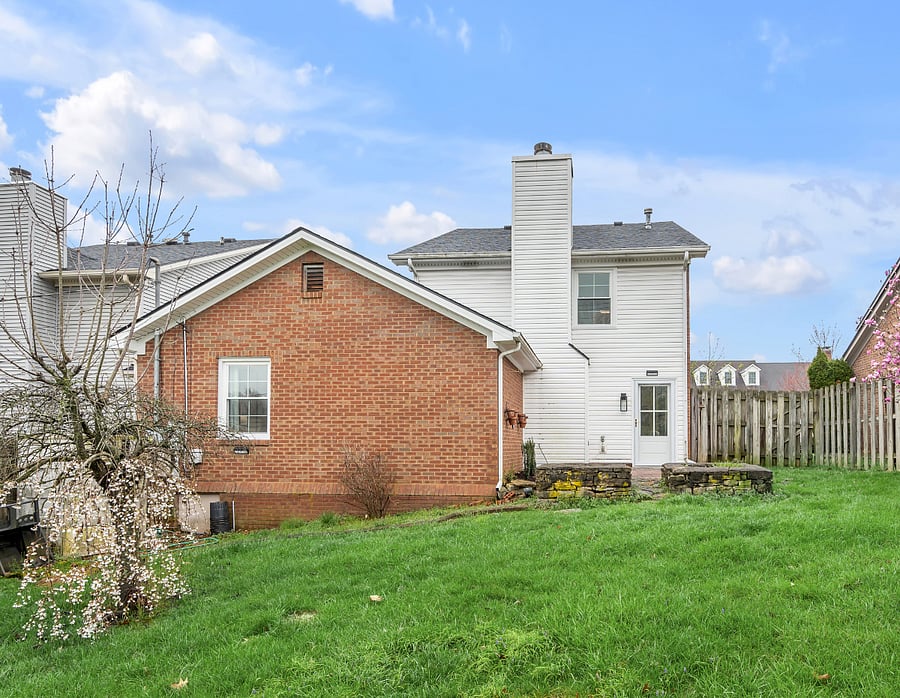 Rear of home with brick patio and fenced backyard that has two raised garden beds ready for your seasonal garden dreams to come true. Rear entry door into living room also comes with keypad for secure keyless entry.