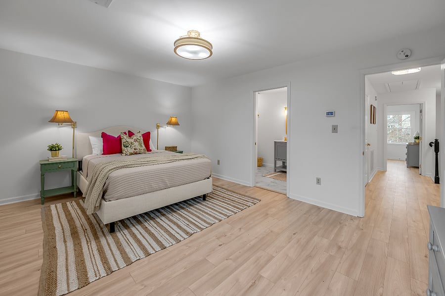 Additional 2nd level master bedroom with view into completely remodeled full bathroom containing 48 inch vanity sink and walk-in shower. Check out those seagrass lampshade sconces that are perfect for your bedtime reading.