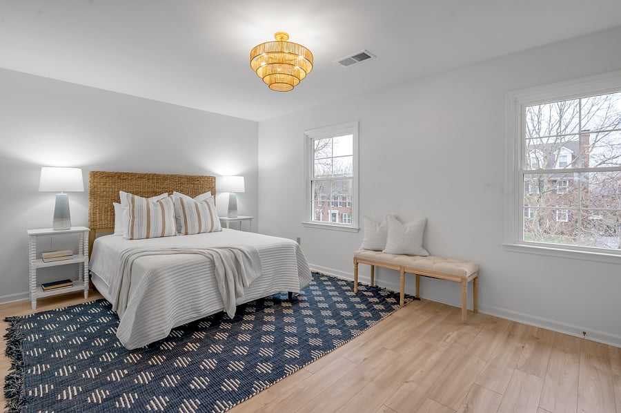 Coastal modern themed 2nd level master bedroom with Queen bed and view of outside front of house.
