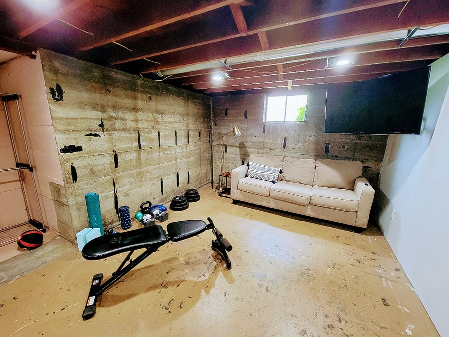 Basement provides ample room for excercise and/or storage. Please note there is a treadmill that is currently out of service. The workout bench in this photo is still out for use, but no other exervise equipment is available.