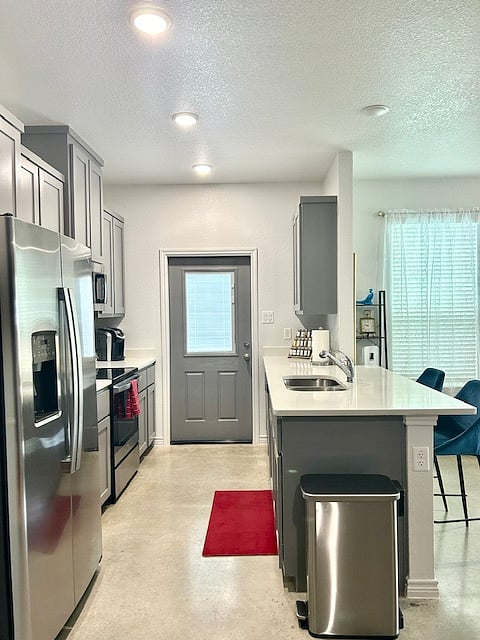 Well equipped kitchen with spice rack.