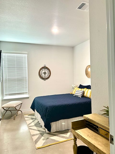 3rd bedroom with queen bed, nice size closet, and standing fan.