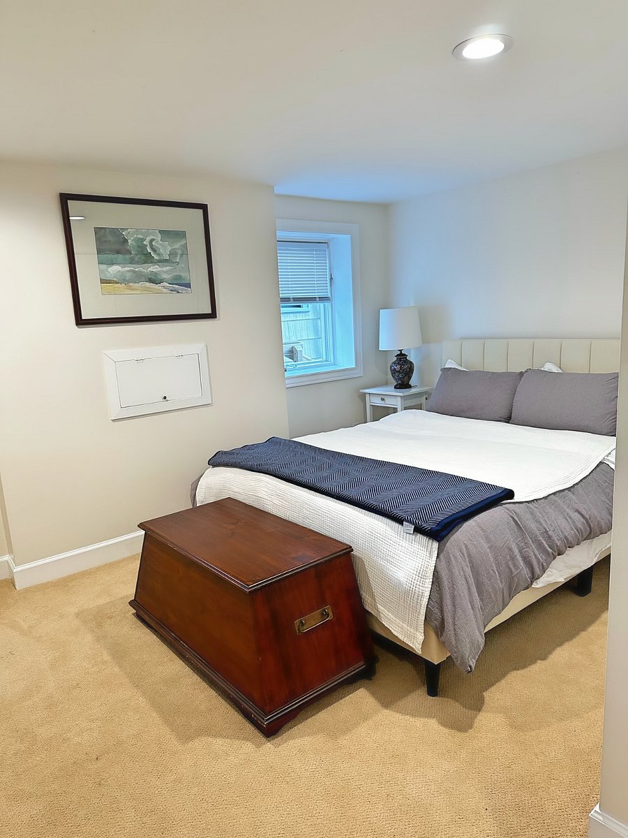 Bedroom with bright windows and queen bed