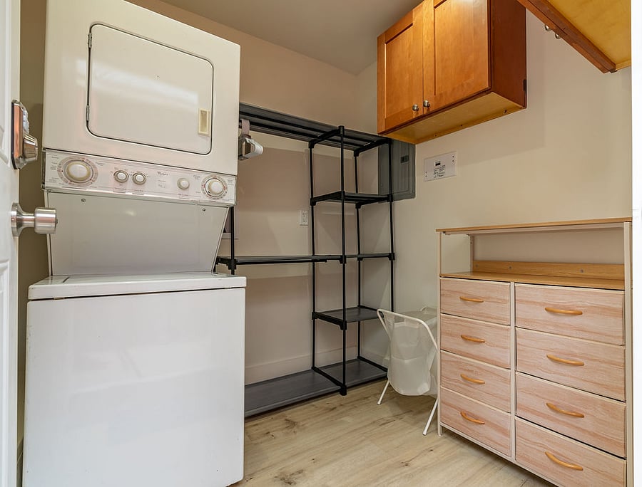 Private laundry room with additional storage and cabinets