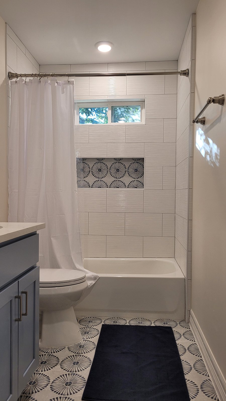 Bathroom with bath and shower combo.