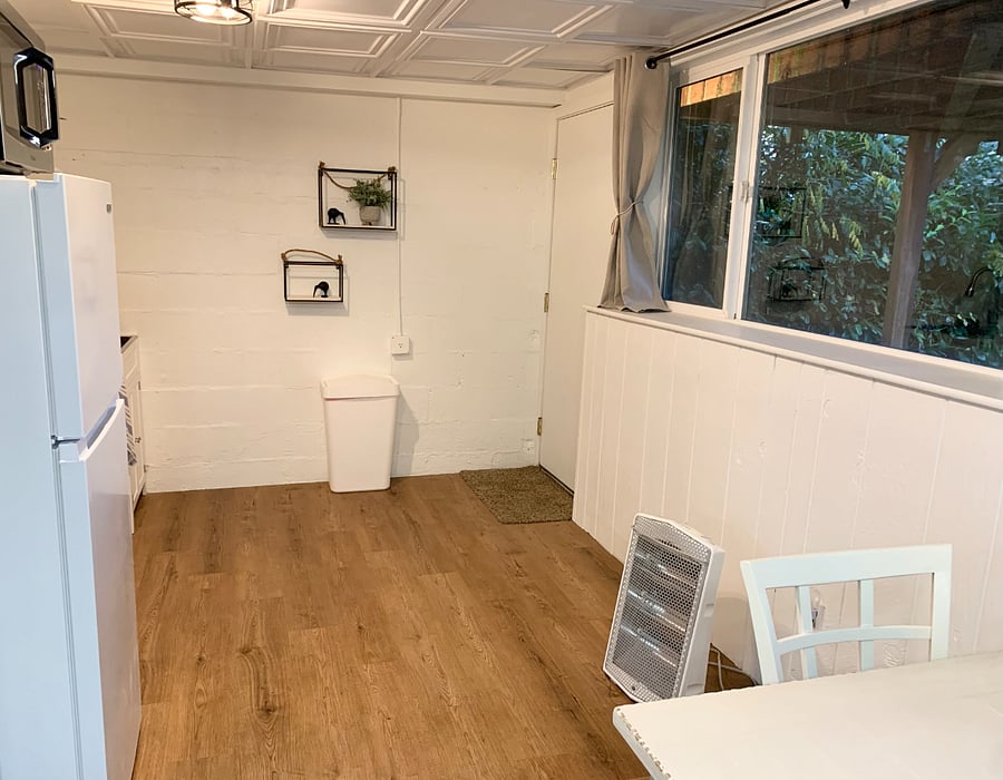 Private entrance with bay view and secluded yard to include full wall of windows.