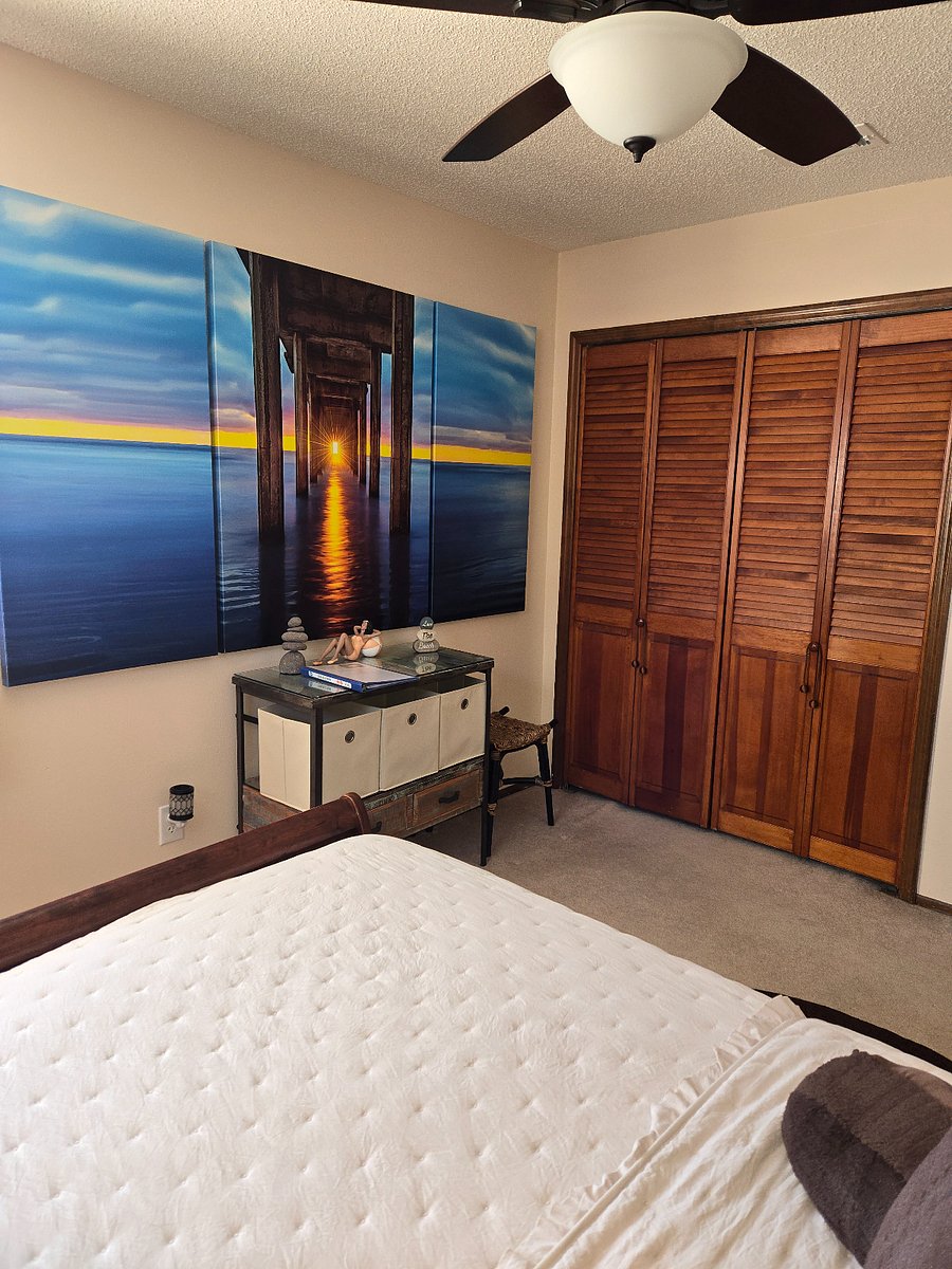Bedroom has peaceful art chosen to enhance your stay. There is also great closet space that comes with hangers, shoe boxes, other organizers, full size iron board, and iron. 