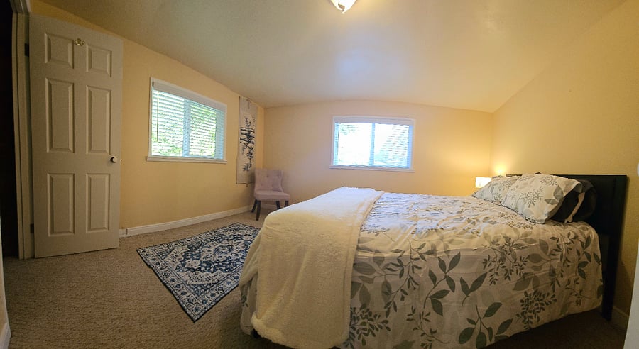Bedroom 1 with Queen Bed, chair, large closet, and chest of drawers.
