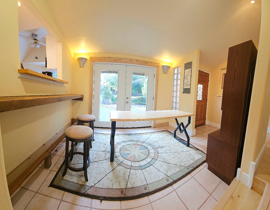Sun room with bar and dining table.
