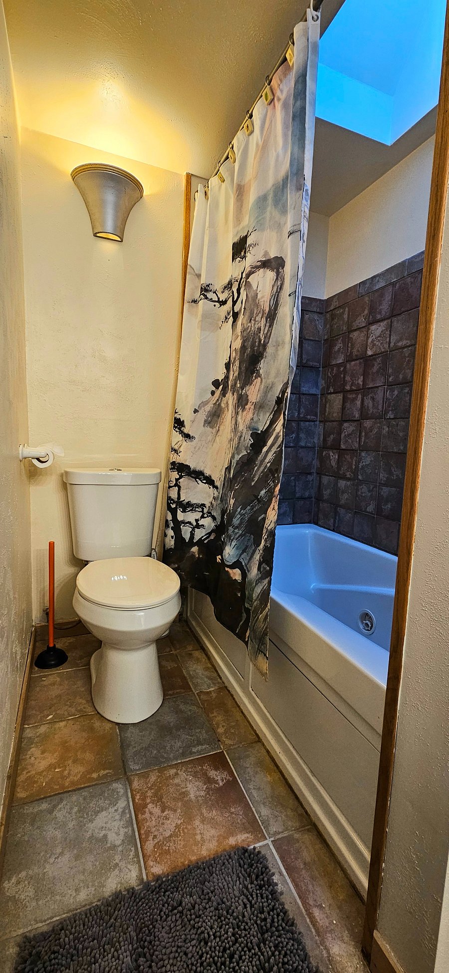 Bathroom with shower, tub and towell storage.
