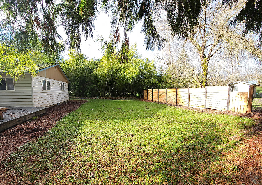 Private back yard with deck and raised bed garden.