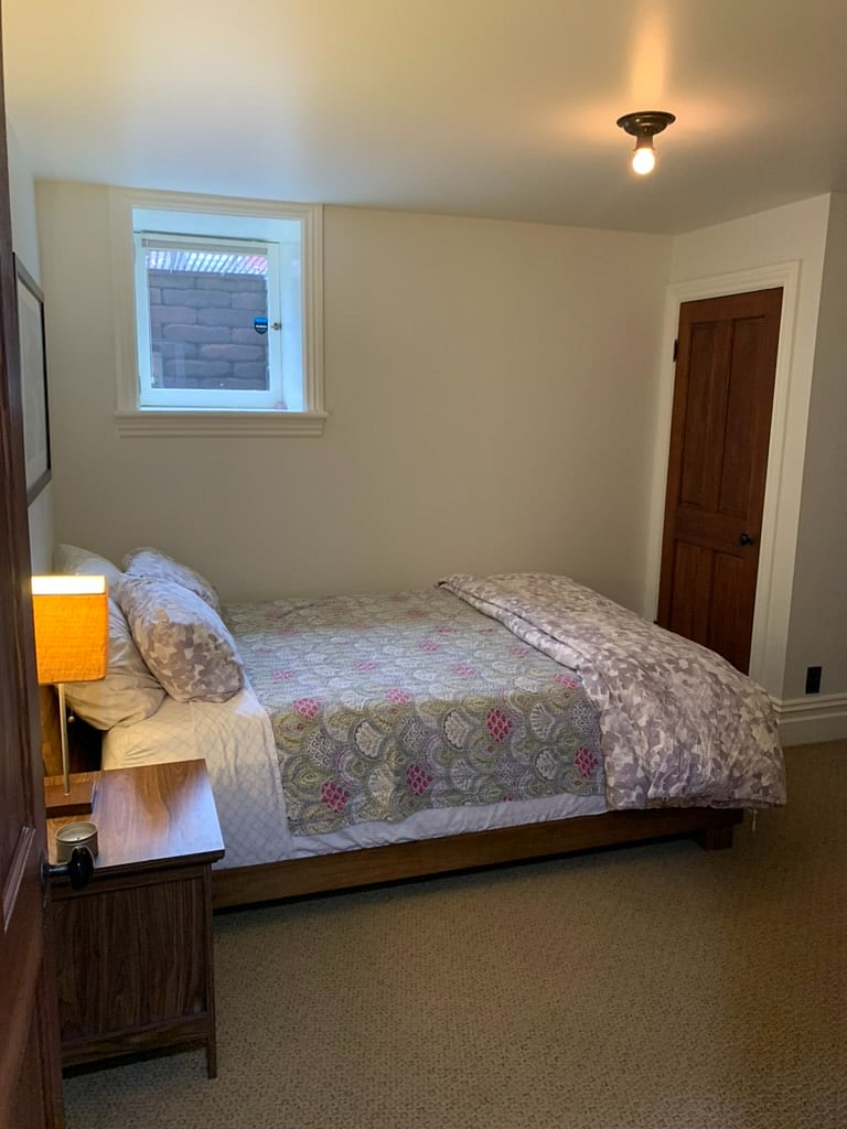 Bedroom - queen bed, new mattress. Dresser, two closets. Door to bathroom.