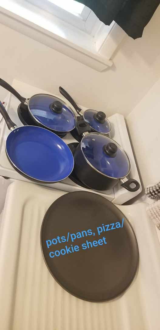Pots Pans under sink on left side, stored below, displayed out for pictures