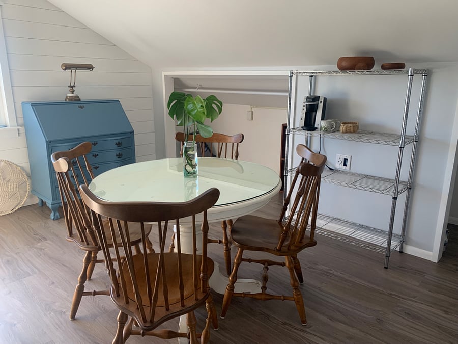 Kitchen table with secretary desk in the background for laptop/office use.