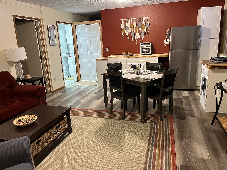 Full refrigerator, storage and amenities. Shows entry door from inside living space.
