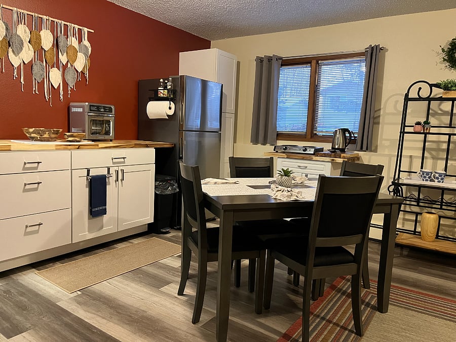 Kitchen area includes 2 burners, toaster oven, air fryer, microwave, rice cooker, electric fry pan, hot pot and coffee pot.