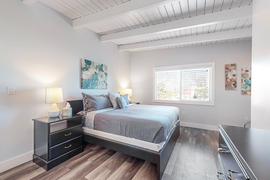 Master bedroom #1 with king-sized bed, walk-in closet, private balcony, full bathroom with separate tub and shower.