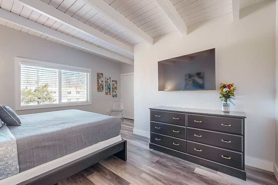 Master bedroom #1 with king-sized bed, walk-in closet, private balcony, full bathroom with separate tub and shower.