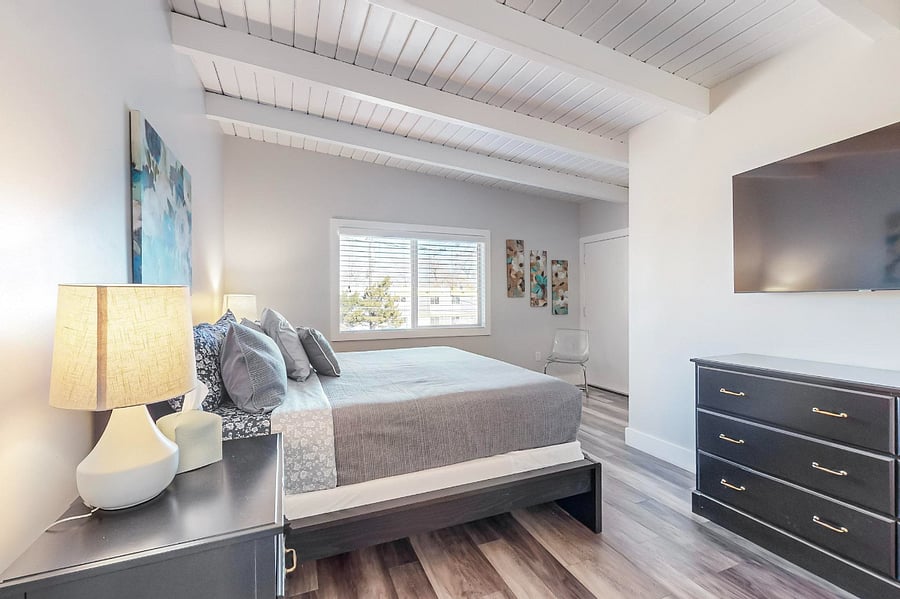 Master bedroom #1 with king-sized bed, walk-in closet, private balcony, full bathroom with separate tub and shower.