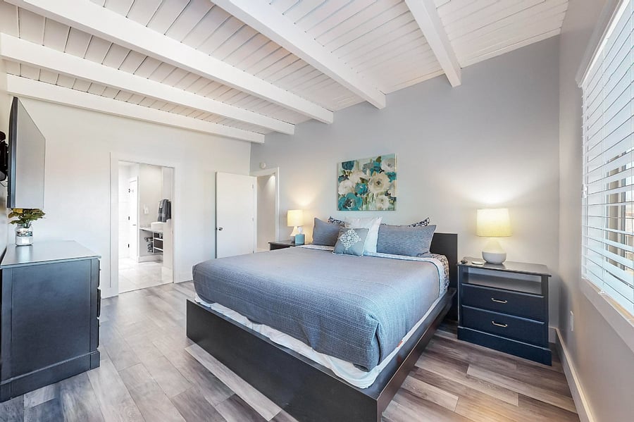Master bedroom #1 with king-sized bed, walk-in closet, private balcony, full bathroom with separate tub and shower.