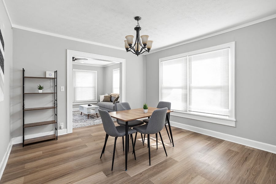 Bright and stylish dining area with modern furnishings and an open flow to the living room.