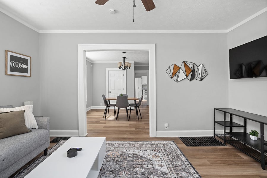 Elegant open-concept living and dining area with modern decor and neutral tones.