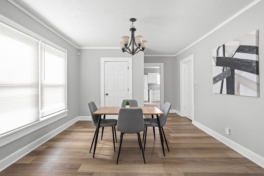 Modern dining space with sleek furniture, minimalist decor, and ample natural light.